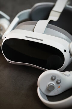 Modern Virtual Reality Headset and Controller on Dark Surface
