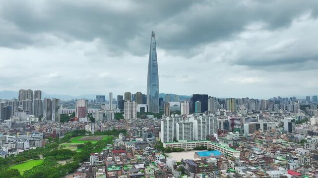 Aerial Drone View of Jamsil Station Cityscape, Lotte World Tower, and Han River Landscape in Seoul, South Korea