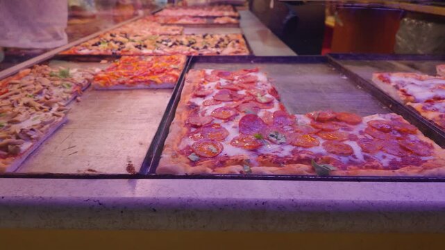 Traditional Italian Pizza Slices Displayed in Florence Bakery