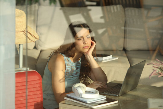 Sad and overwhelmed student studying on vacation
