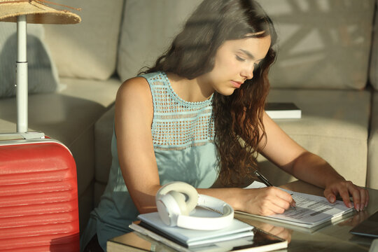 Student on vacation filling form studying in an hotel room