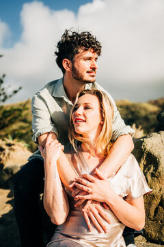 Young couple embracing in the sun outdoors