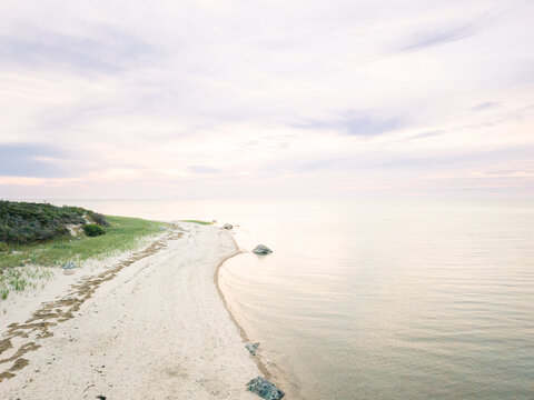 Pastel sunrise over a quiet deserted beach aerial photo