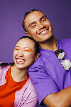 Young friends smile together in a colorful headshot portrait with beauty and joy