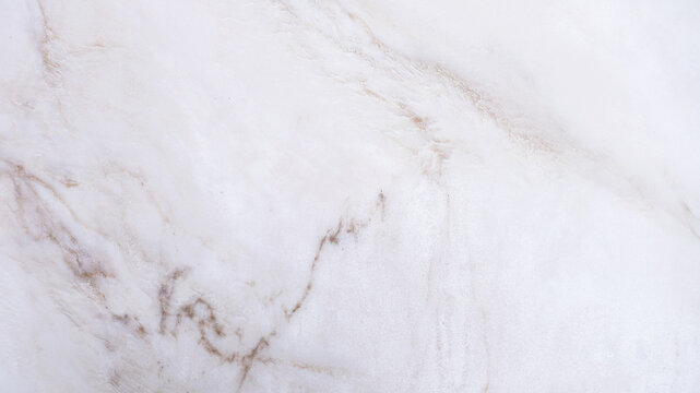 White marble surface with light brown veining pattern background