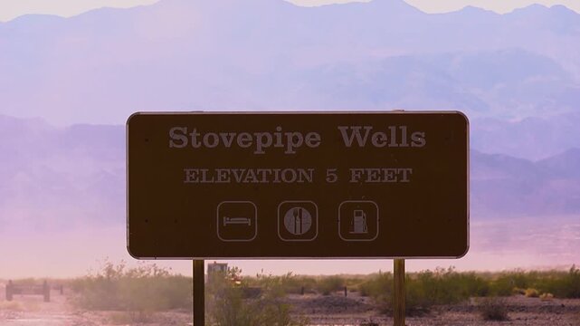 Dust blowing by Stovepipe wells welcome sign