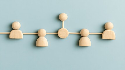Obraz premium Wooden figures connected by lines on a soft blue background. Concept for team networking, hierarchy and human.