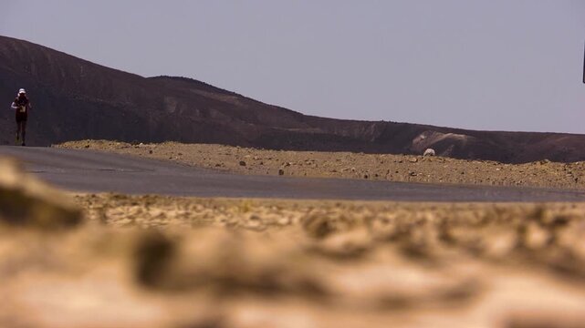 heat coming off the ground in death valley as marathon runners push through