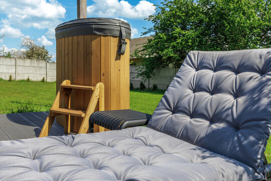 Outdoor Spa Zone with Wooden Hot Tub and Sun Lounger