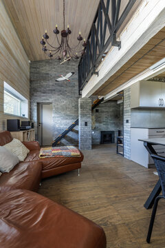 Modern Country House Interior with Leather Sofa and Chandelier