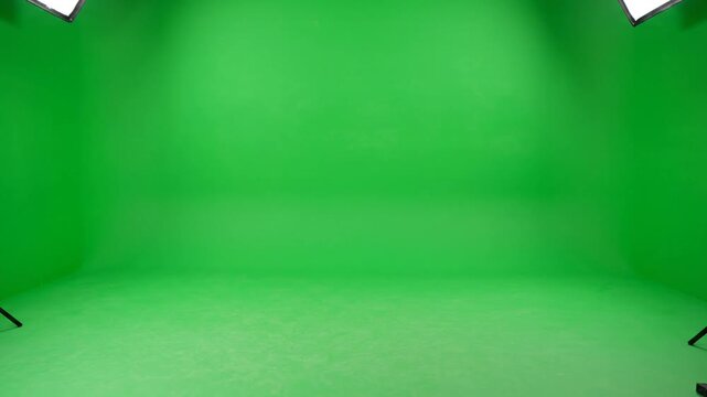 Empty green screen studio with lighting setup.