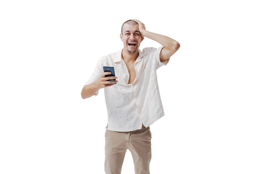 Frustrated Young Man Holding Smartphone and Touching Head in Regret