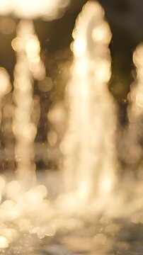 Illuminated Water Fountains Emanating Soft Reflections and Blur Under Afternoon Sunlight, Creating a Dreamy Atmosphere in a Scenic Outdoor Setting
