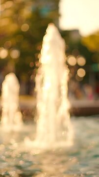 A Serene Evening at the Fountain: Captivating Water Jets Dance in the Warm Golden Light of Dusk, Creating a Magical Experience for Onlookers.