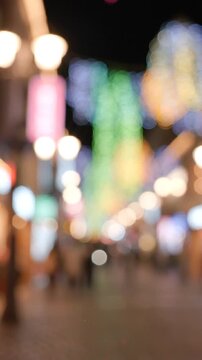 A Vibrant Evening Scene Bursting with Colorful Lights and Atmosphere, Capturing the Essence of a Lively Urban Night with Blurred Perspectives and Captivating Bokeh Effects