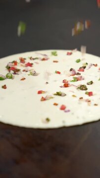 Chopped Vegetables Added to Dosa Batter on Pan