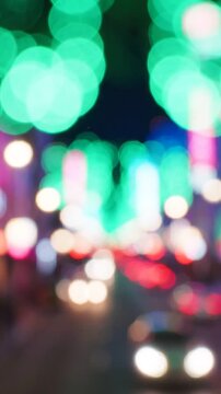 A vivid display of colorful lights blurring together in a bustling urban environment captured at night, showcasing the vibrancy and energy of city life in motion.