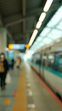 A Softly Blurred Scene of an Urban Train Station Platform with Bokeh Lights, Capturing a Serene Atmosphere Amidst the Anticipation of Arriving Trains