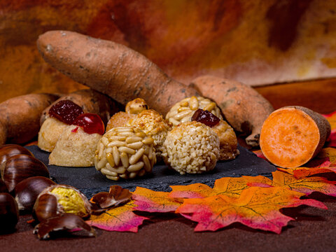 Panellets, sweet potatoes, chestnuts, and autumn leaves celebrating castanyada