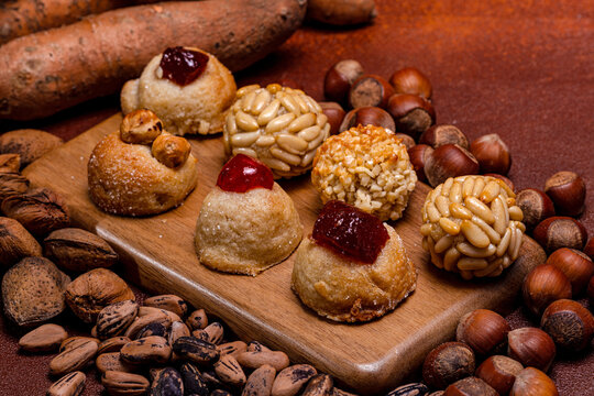 Panellets, traditional catalan sweets celebrating castanyada, on wooden board