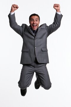 Businessman jumping celebrating success and achievement