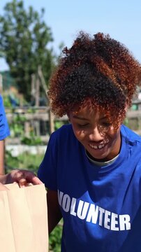 Volunteers packing fresh organic vegetables into bags