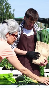 Farmer selling fresh organic vegetables at an outdoor market
