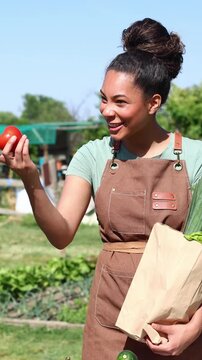 Female farmer selling fresh organic vegetables to a customer