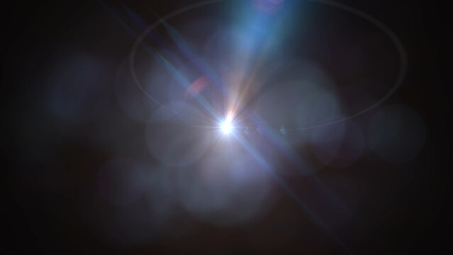 Bright light bursts through darkness, creating radiant lens flares