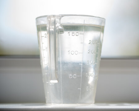 Transparent measuring cup filled with water