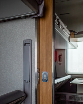 Interior of a train compartment with a folded seat.