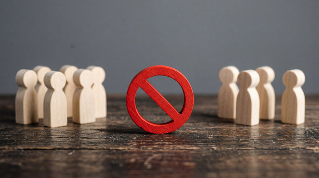 Red no symbol placed in the center between two groups of wooden figures standing in a room