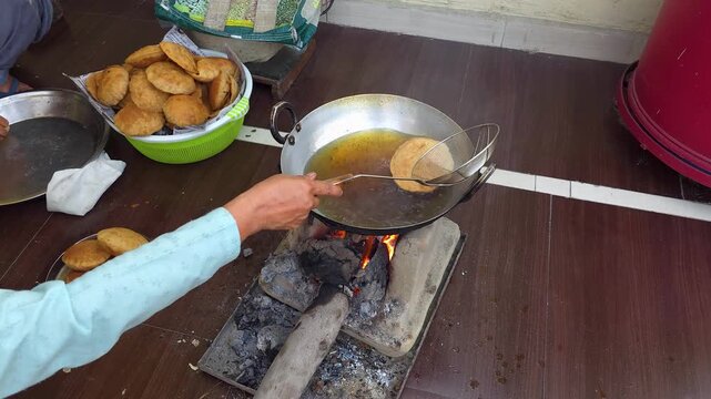 Cooking traditional deep fried snacks in a pan over a wood burning stove food frying snack fire