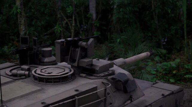 Tank turret with barrel poised over undergrowth, clear gun mantlet and optics, atmosphere of readiness and controlled firepower in humid forest environment.