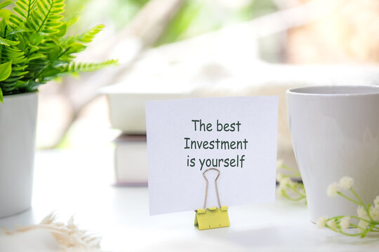 Notepad with the best investment is yourself. Inspirational workspace promoting self investment, personal growth and lifelong learning.  Goal Life and Investment Wellness Concept.