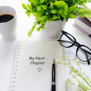 Notebook with my next chapter message inspiring new beginnings and future life planning.  Goal Life Wellness Concept.