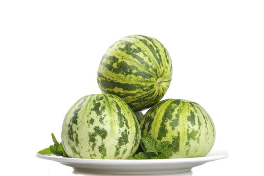 Fresh Ripe Watermelons with Green Striped Skin on White Plate with Mint Leaves