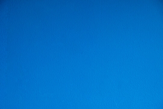 Solid Bright Blue Textured Wall Surface Abstract Background.