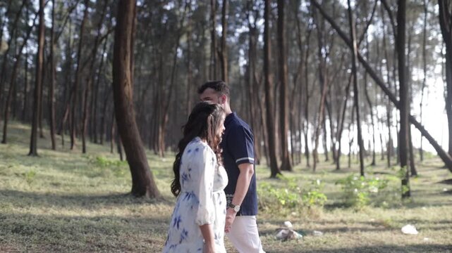 Romantic Couple Walking Together in a Serene Pine Forest During Daylight