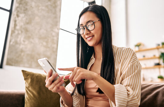 Young woman using smartphone at home