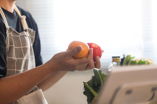 Middle Aged Asian Man Choosing Fresh Fruit for Healthy Aging