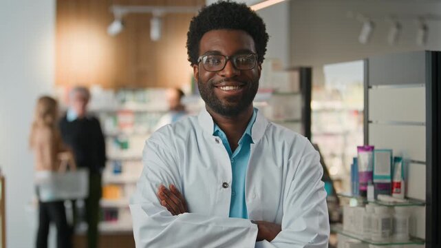Portrait happy African American man pharmacist doctor posing crossed hands in pharmacy optimistic male health care medicine worker chemist smile looking at camera crossing arms working in drugstore