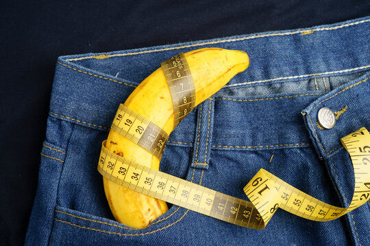 Banana with measuring tape on jean trousers, penis health.