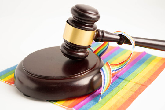 Gavel for judge lawyer on rainbow flag, symbol of LGBT pride month.