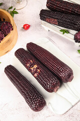 Fresh Black Sticky Corn Cobs with Jade Kernels on White Marble Surface - Healthy Organic Food Photography © BuiThi