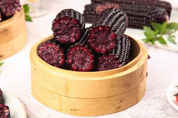 Sweet Black Sticky Corn Cobs in Bamboo Steamer - Fresh Organic Purple Kernels Heirloom Variety © BuiThi