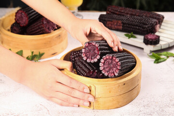 Traditional Purple Black Sticky Rice Corn in Bamboo Steamer - Asian Cuisine Preparation © BuiThi