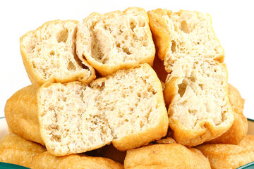 Fototapeta premium Fried Tofu Puffs with Hollow Texture - Golden Cooked Bean Curd for Asian Cuisine