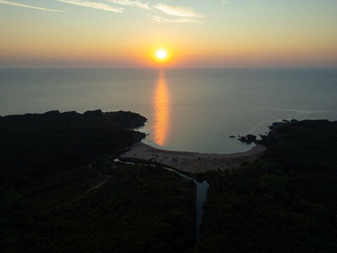 Drone Flying Forward Over Silistar Beach Bay at Golden Sunrise Sunset