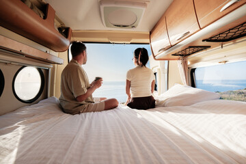 Naklejka premium Couple enjoying a serene morning view in a van overlooking Chalkidiki's stunning coastline